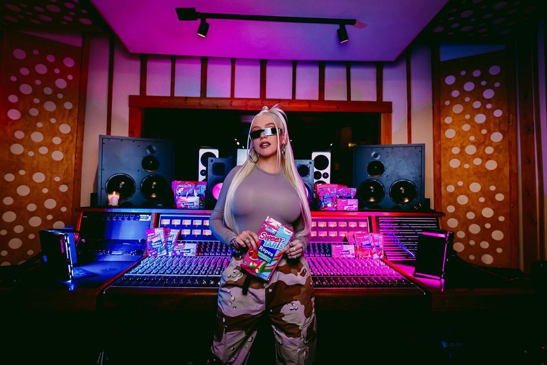 Christina Aguilera in a studio and poses for SweeTARTSCandy